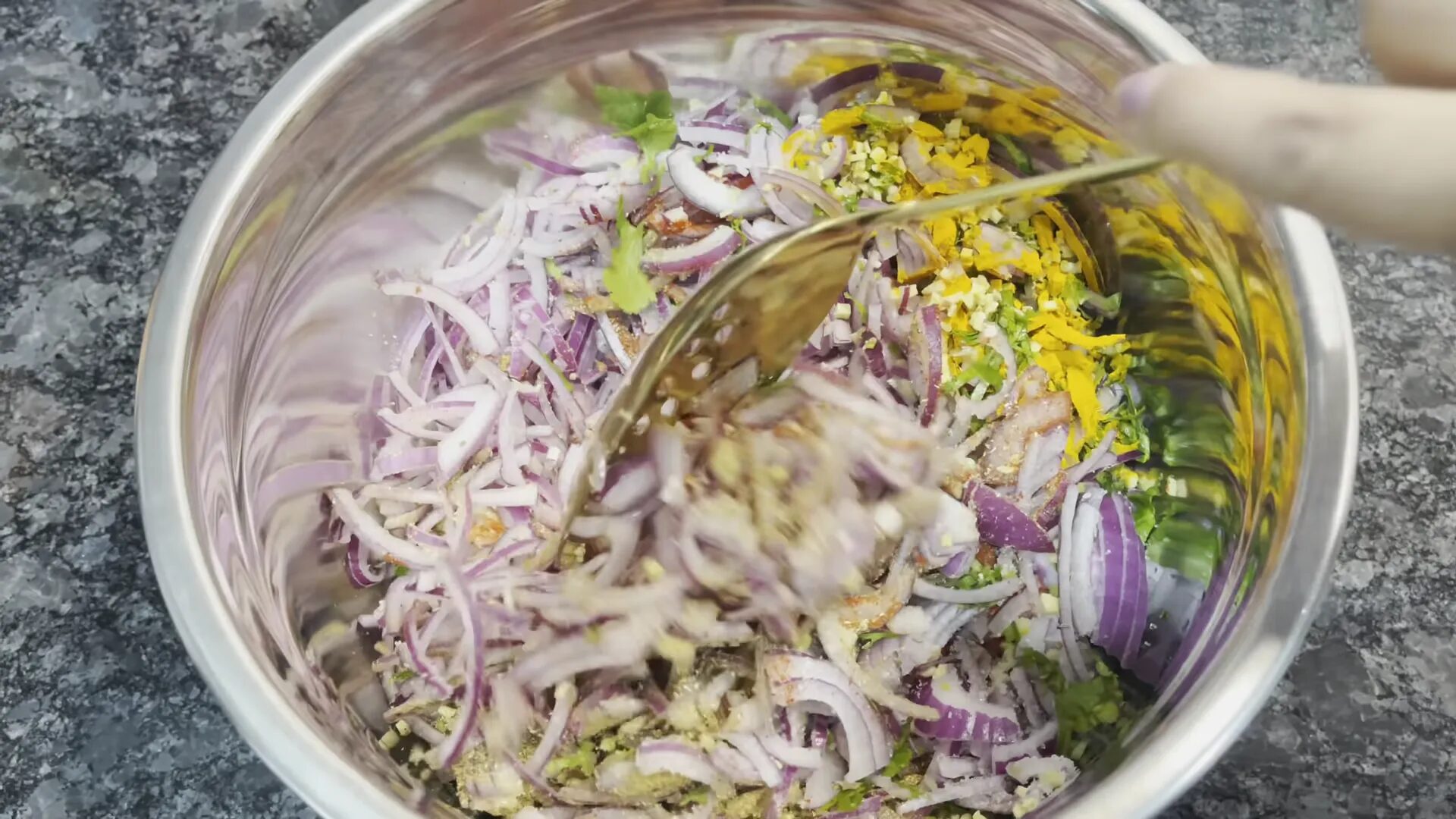 Mixing onions with spices