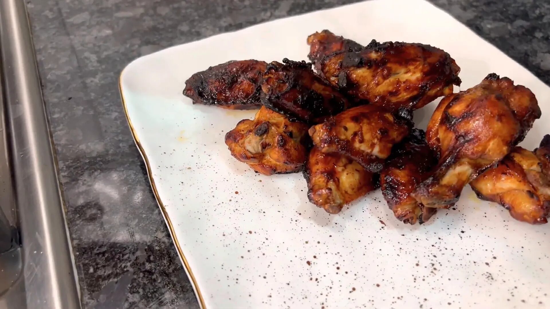 Brushing marinade on chicken wings