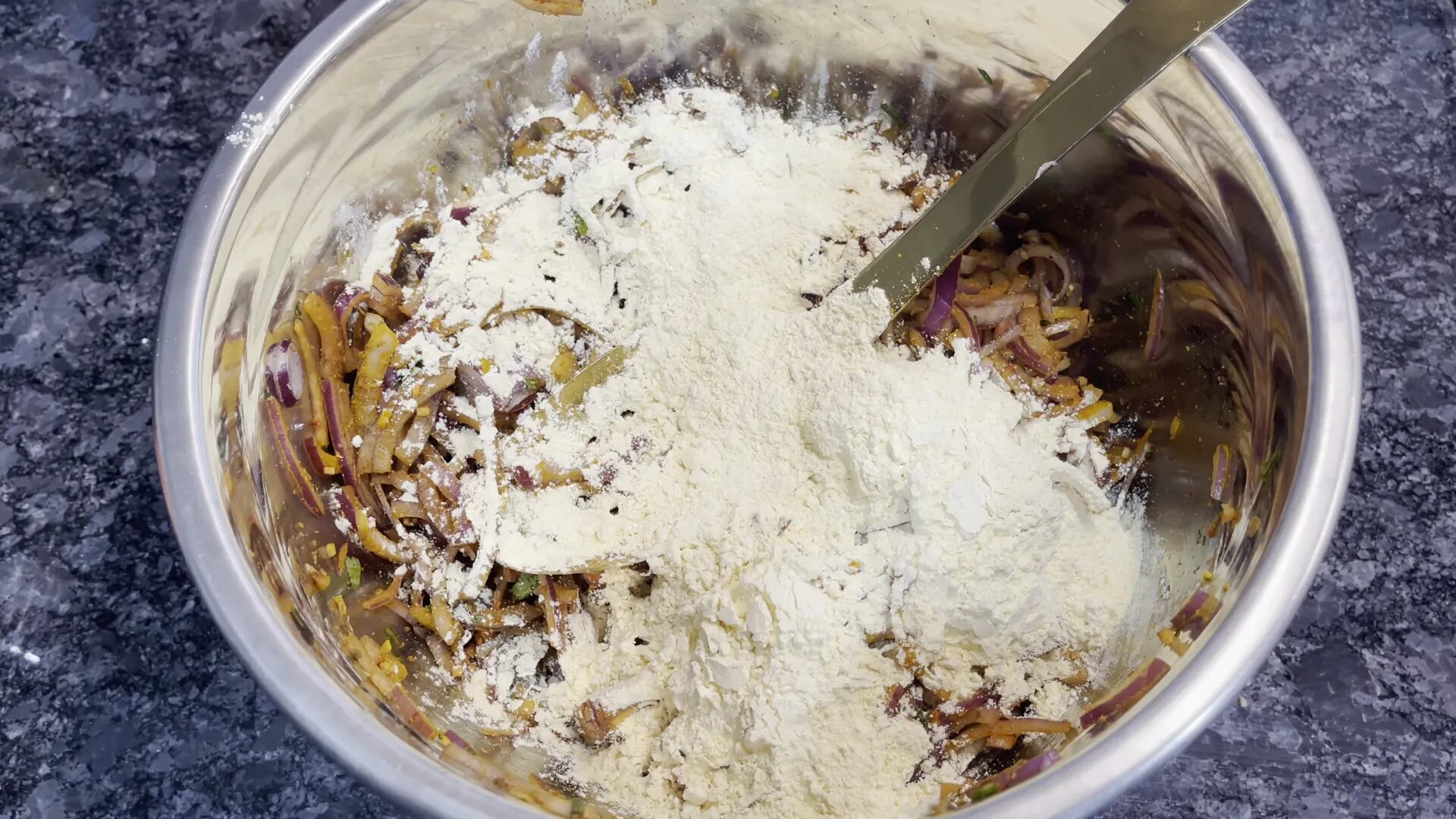 Adding besan to onion mixture