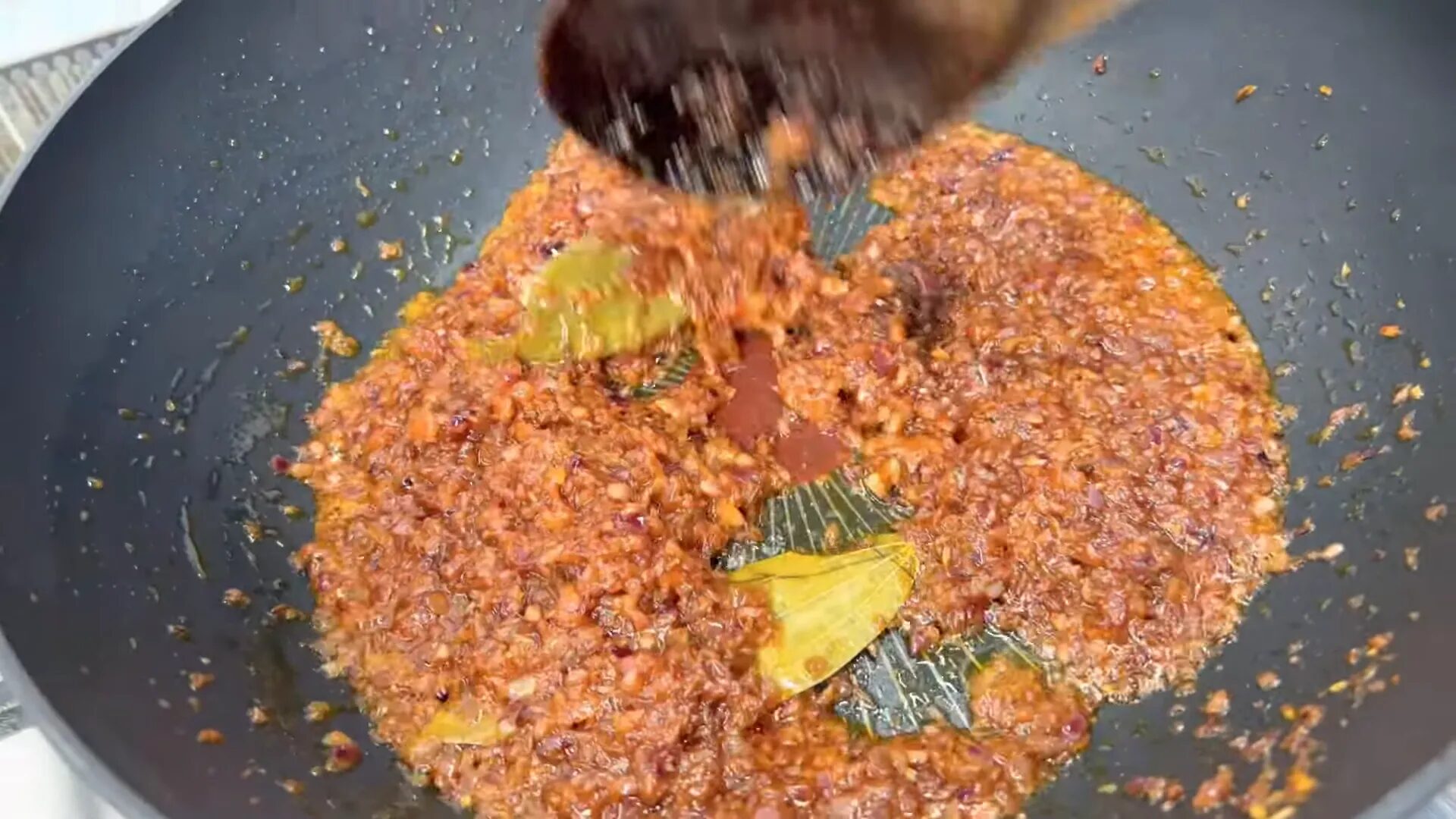 Adding tomatoes to the sautéed onions