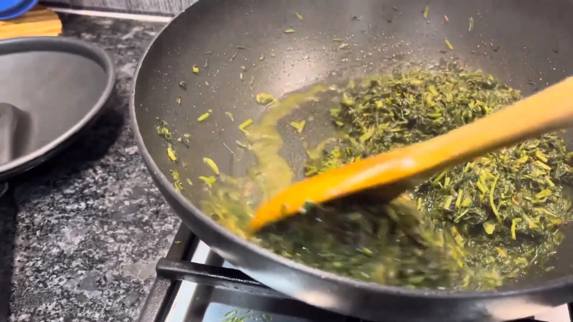 Mixing cooked potatoes with methi
