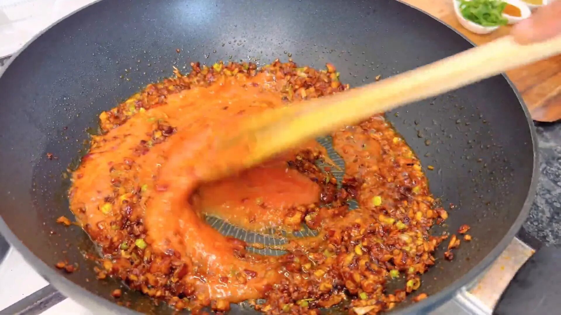 Adding tomato puree to the mixture